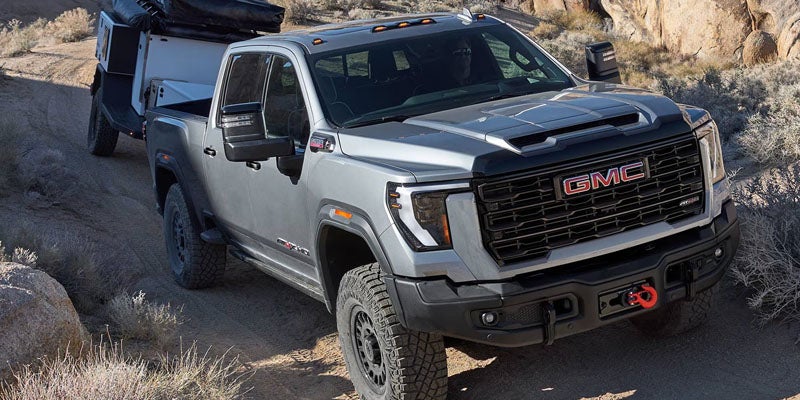 2026 Sierra 2500 HD AT4 trim navigating rugged off-road terrain