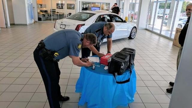 two people sign the documents